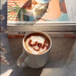 a table with a book and a cup of coffee