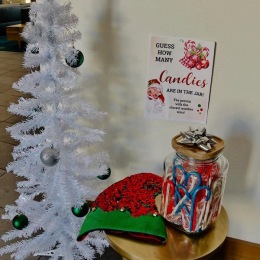 a Christmas tree and a table with a jar of candy canes