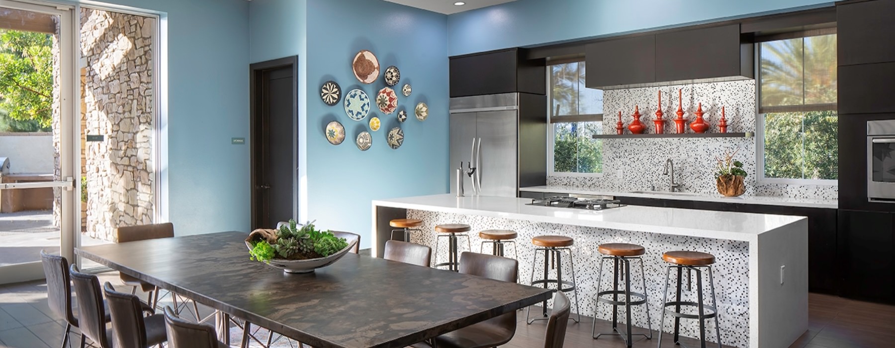 a kitchen with tables and chairs